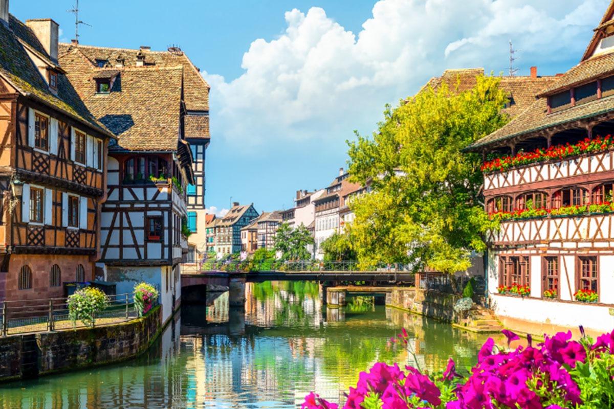 View of the Rhine lined with old buildings and flowers