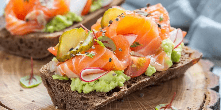 image of food - salmon and avocado on bread with radish