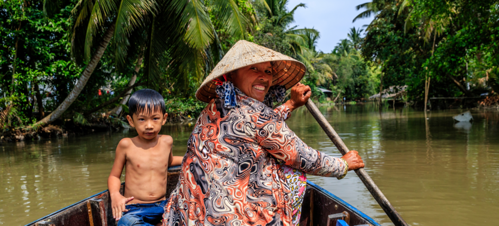 Mekong River boat lady and kid
