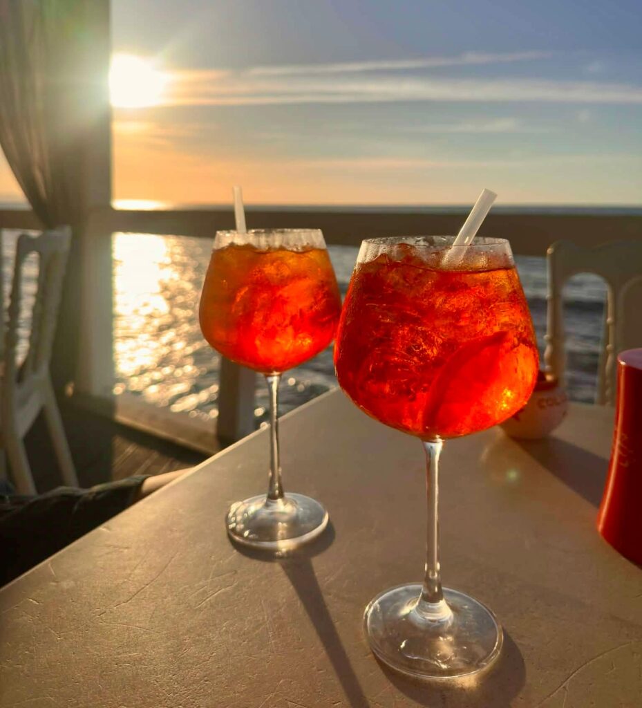 two cocktails with ocean background