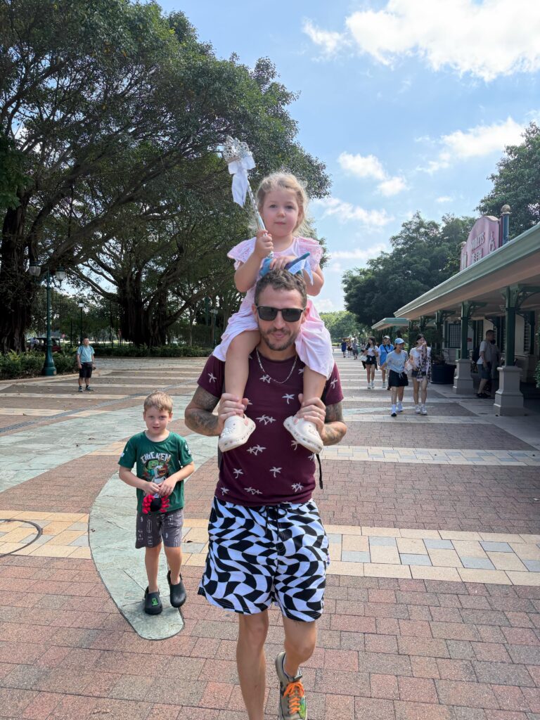 Brit's husband carrying Lucy around Disneyland
