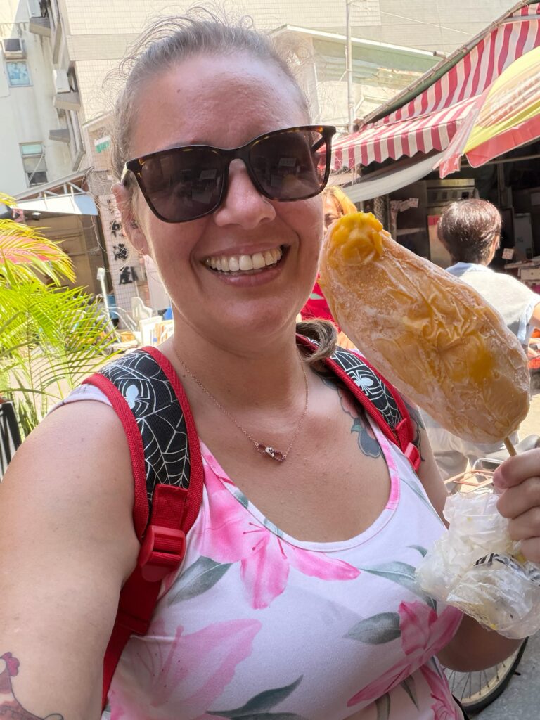 Brit eating food on a stick