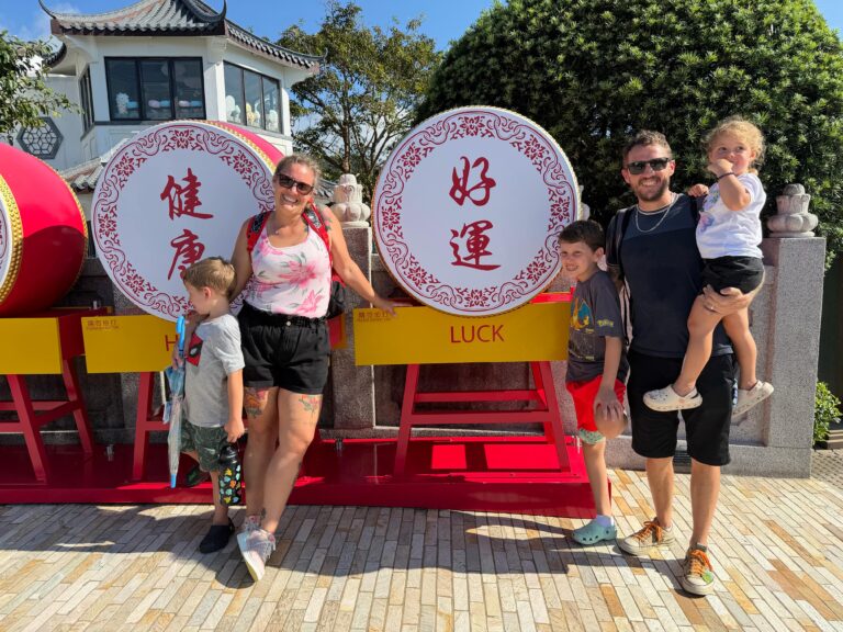 Brit's family in front of the Ngong Ping symbols