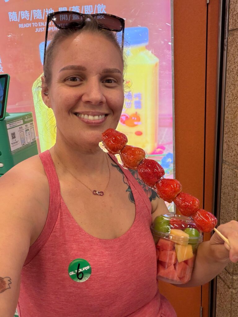 Brit eating strawberries on a stick